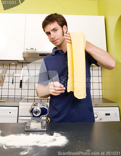 Image of Happy Male Making Pasta