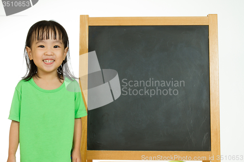 Image of Chinese little girl with blank blackboard