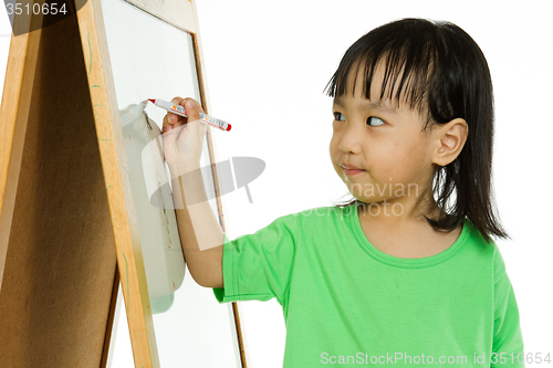 Image of Chinese little girl writing on whiteboard