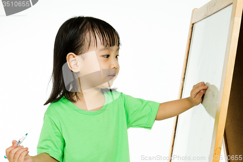 Image of Chinese little girl writing on whiteboard