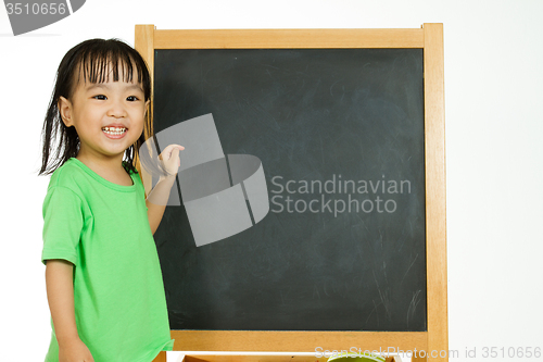 Image of Chinese little girl with blank blackboard