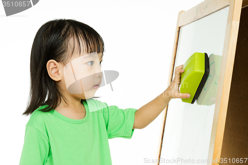 Image of Chinese little girl writing on whiteboard