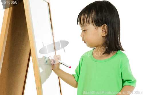 Image of Chinese little girl writing on whiteboard