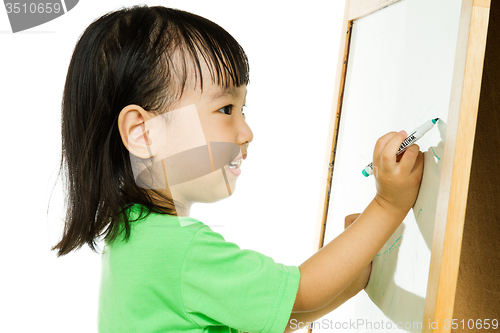 Image of Chinese little girl writing on whiteboard