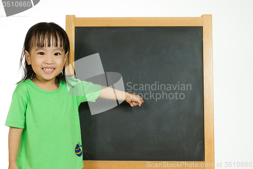 Image of Chinese little girl with blank blackboard