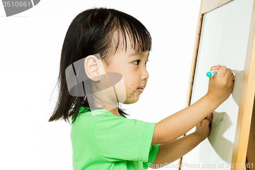 Image of Chinese little girl writing on whiteboard