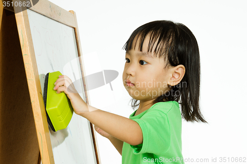 Image of Chinese little girl writing on whiteboard