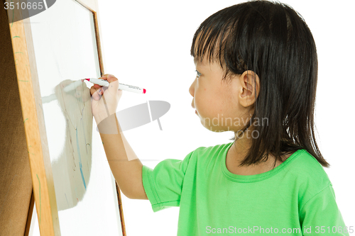 Image of Chinese little girl writing on whiteboard