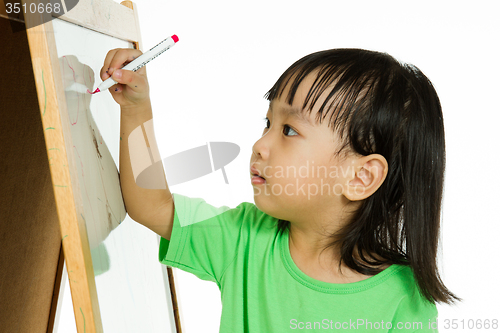 Image of Chinese little girl writing on whiteboard