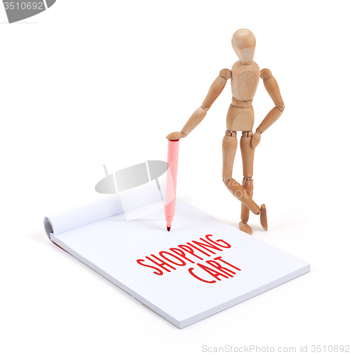 Image of Wooden mannequin writing - Shopping cart