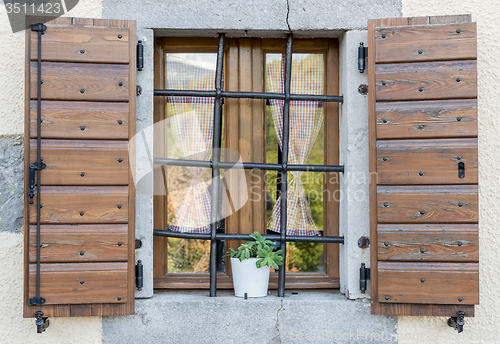 Image of window with open wooden shutters 