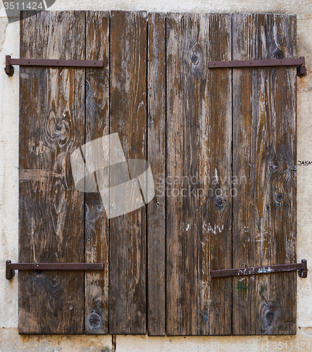 Image of old window with  closed wooden shutters