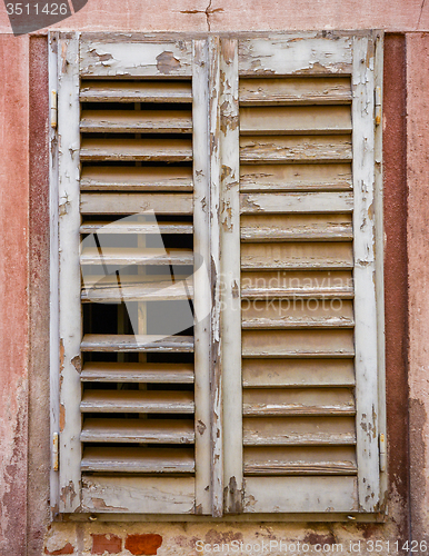 Image of window with  closed wooden shutters