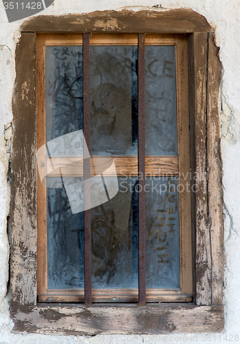 Image of old window with metal bars