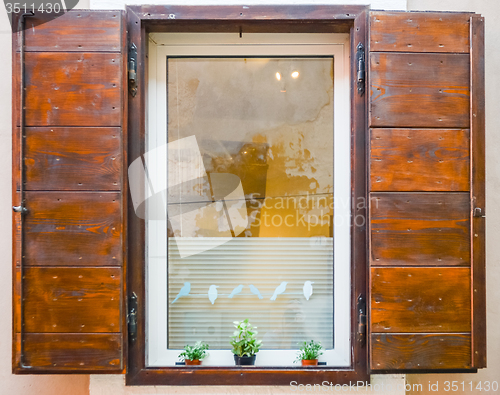 Image of window with open wooden shutters