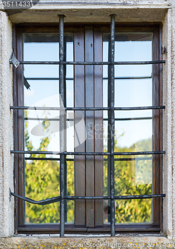 Image of old window with metal bars 