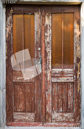 Image of old ragged shabby wooden door