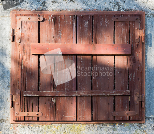 Image of old window with  closed wooden shutters