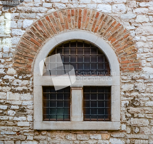 Image of old window with metal bars 