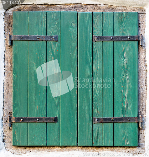 Image of old window with  wooden shutters