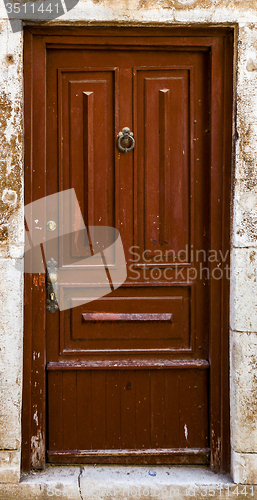 Image of brown ragged shabby wooden door