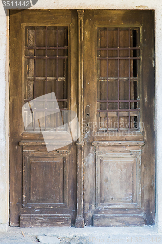 Image of old brown ragged shabby wooden door