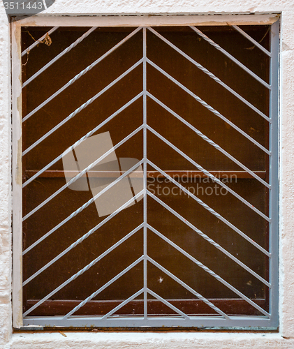 Image of old window with metal bars 