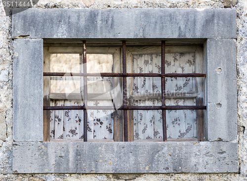 Image of old window with metal bars