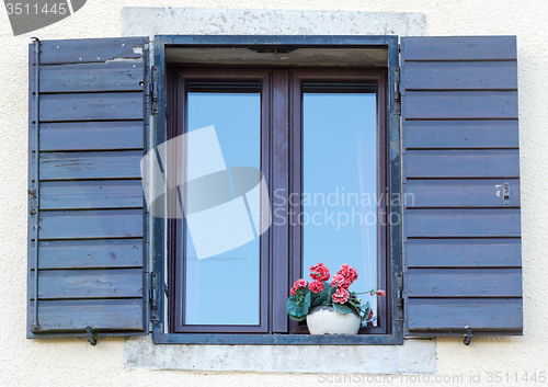 Image of window with open wooden shutters 
