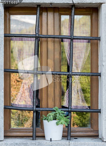 Image of old window with metal bars