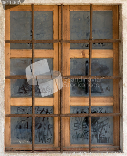 Image of old window with metal bars