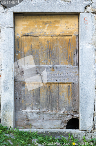 Image of old ragged shabby wooden door