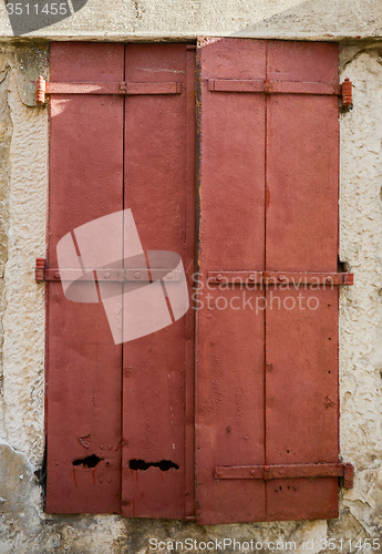 Image of old window with  closed wooden shutters