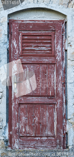 Image of old brown yellow ragged shabby wooden door