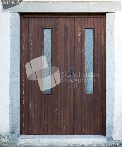 Image of old brown ragged shabby wooden door