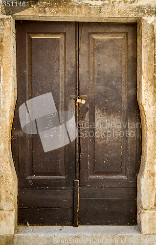 Image of old brown yellow ragged shabby wooden door