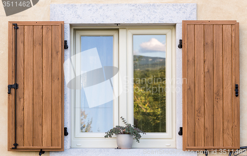 Image of window with open wooden shutters