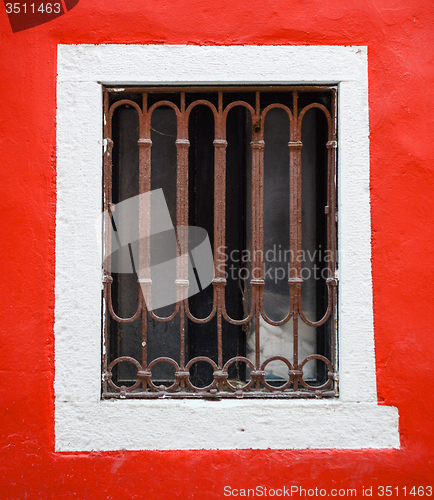 Image of old window with metal bars 