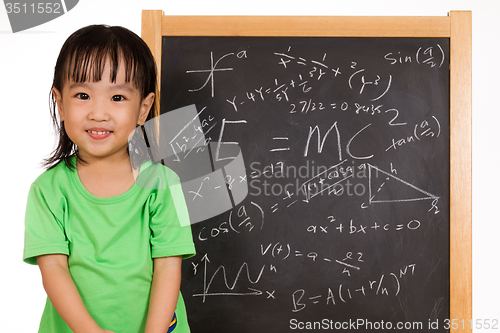 Image of Asian Chinese little girl againts blackboard with formulas