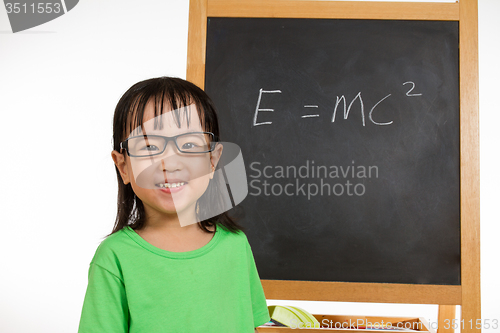 Image of Asian Chinese little girl againts blackboard with formulas