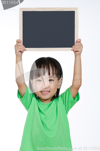 Image of Asian Chinese little girl holding chalkboard 