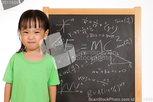 Image of Asian Chinese little girl againts blackboard with formulas