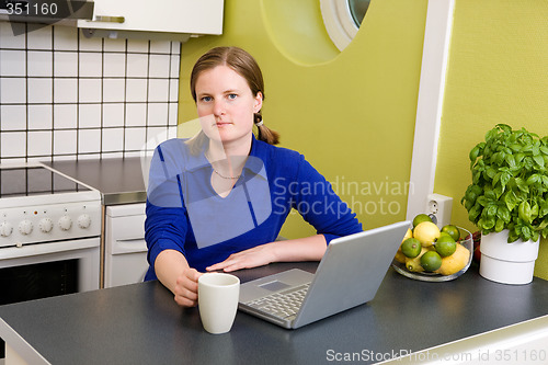 Image of Young woman with Computer and Coffee