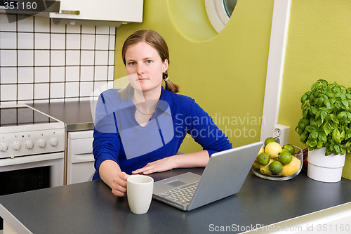 Image of Young woman with Computer and Coffee