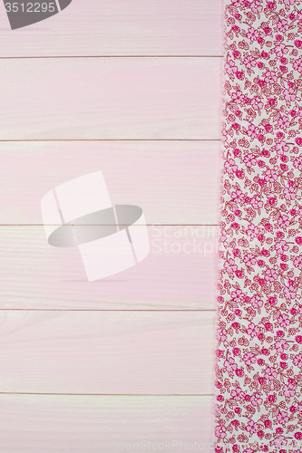 Image of Pink towel over wooden table
