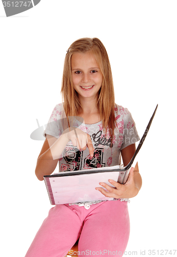 Image of Schoolgirl pointing at her book.