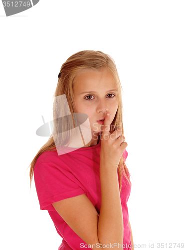 Image of Pretty blond girl with finger over mouth.