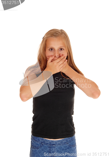 Image of Young girl holding hands over mouth.