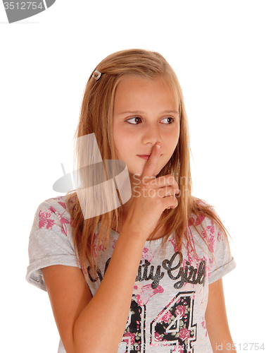 Image of Young pretty girl with finger over mouth.