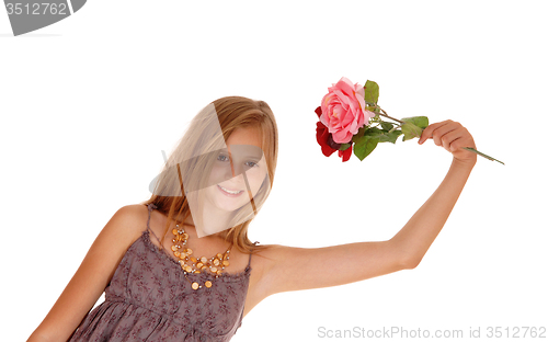 Image of Lovely girl holding up two roses.